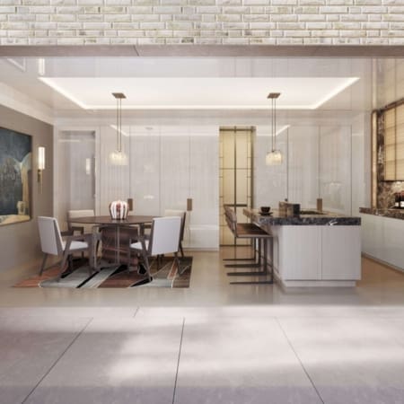 Janine Stone & Co interior design — Eaton Place, Belgravia basement extension kitchen-diner with exposed-brick ceiling, glass-fronted joinery, suspended pendants and bespoke central island.
